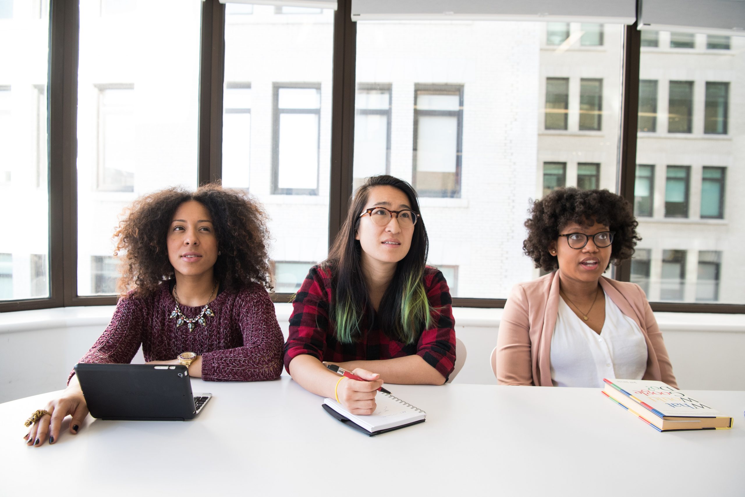 three women in an office staring at something