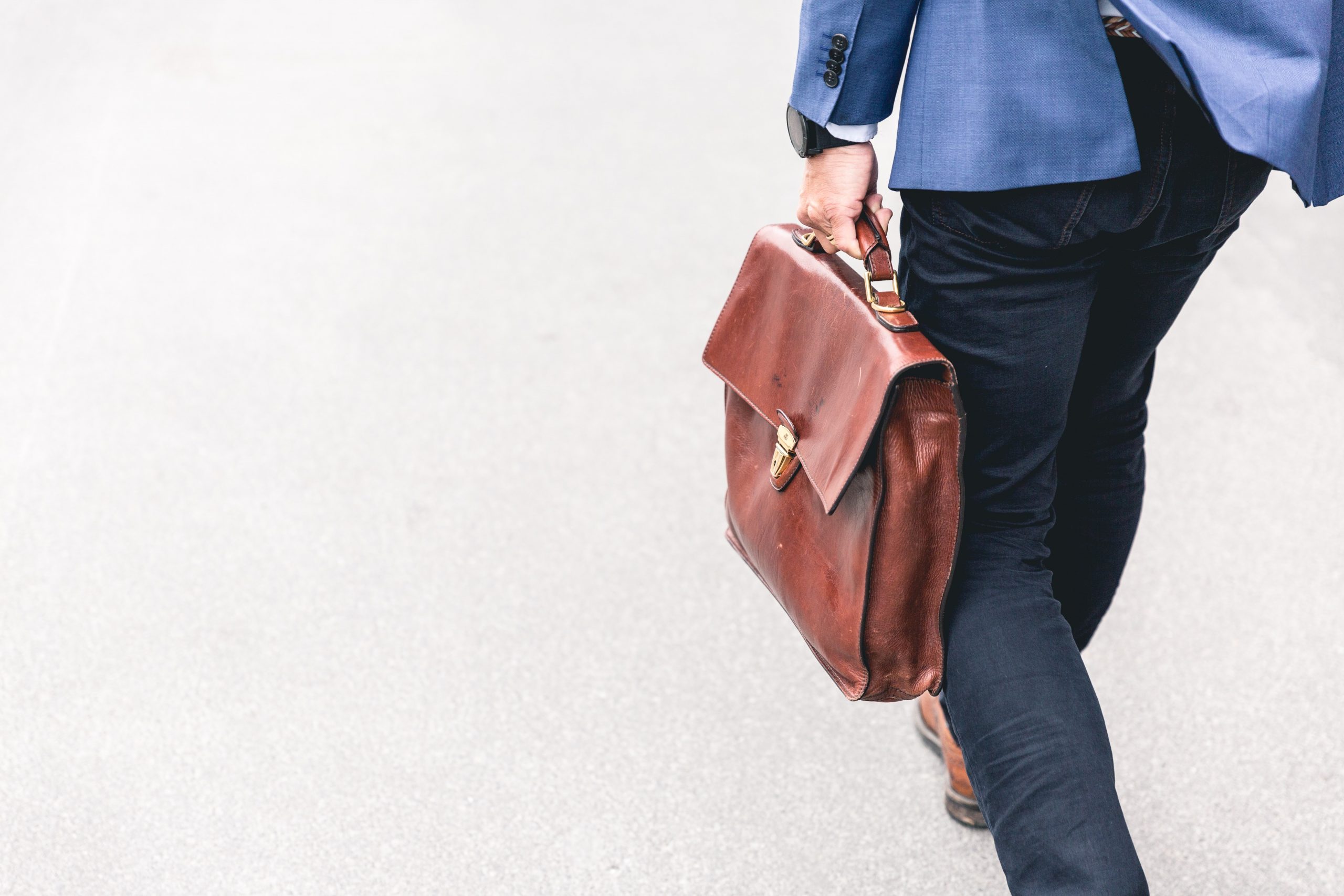 a man carrying a brown bag